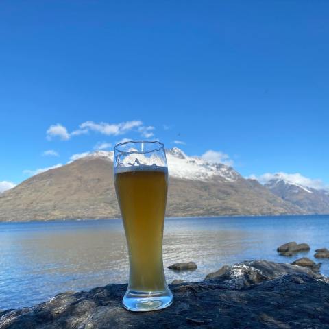a glass of water next to a body of water