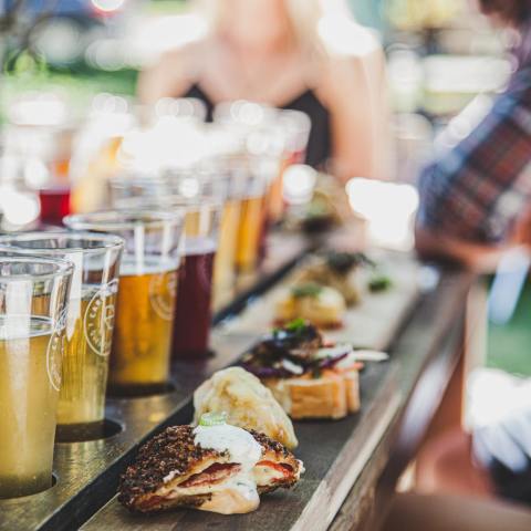 a group of people sitting at a table with food