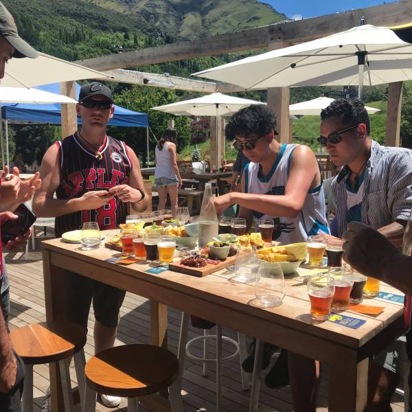 a group of people sitting at a picnic table