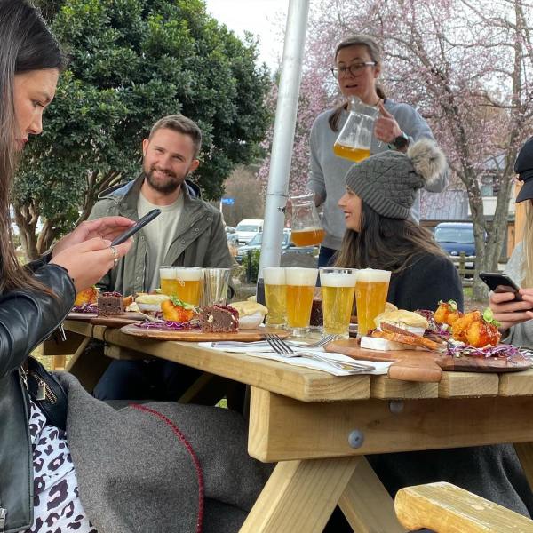 a group of people eating at a picnic table
