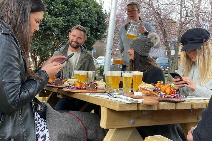 a group of people eating at a picnic table