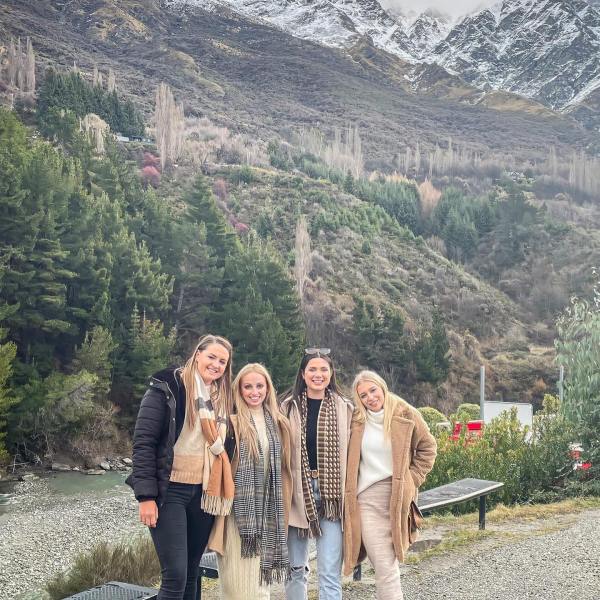 a group of people standing on top of a mountain